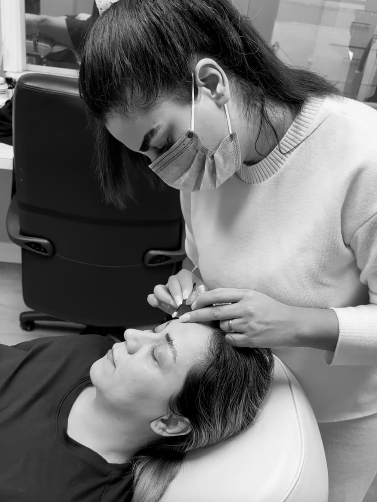 Ronak Iranpour performing a brow treatment at R-Brows Boutique